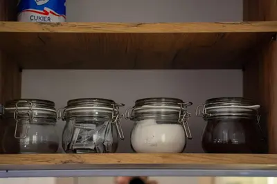 a shelf with four jars of milk on it at Ekskluzywny apartament + garaż in Kraków