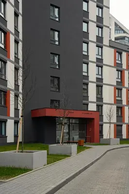 an apartment building with a red and black facade at Ekskluzywny apartament + garaż in Kraków