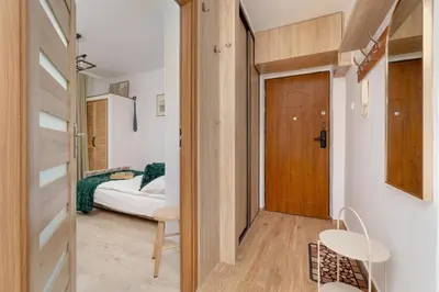 a small room with a bed and a door at Comfortable Apartment with Balcony in Krakow by Rent like home in Kraków