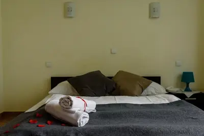 a bedroom with a bed with towels on it at Zajazd Kwadrat in Dąbrowa Górnicza