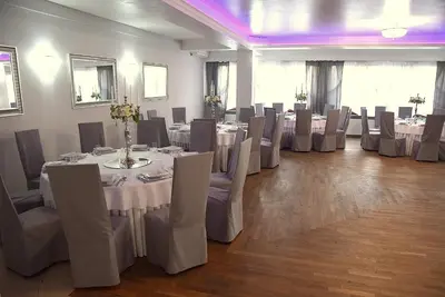 a banquet hall with tables and chairs with white table cloth at Zajazd Kwadrat in Dąbrowa Górnicza
