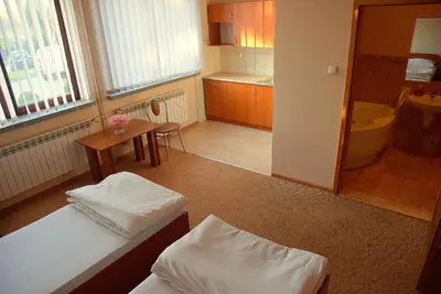 a small room with two beds and a bathroom at Zajazd Kwadrat in Dąbrowa Górnicza