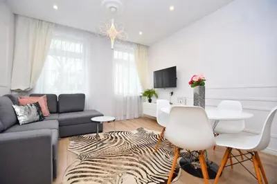 a living room with a couch and a table at Elegant apartment in the perfect location in Kraków