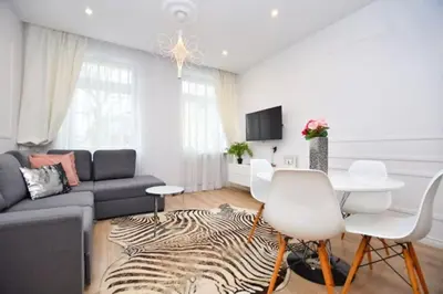 a living room with a couch and a table at Elegant apartment in the perfect location in Kraków