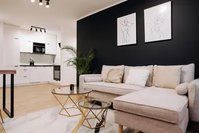 a living room with a couch and a table at Best of Azory apartment in Kraków