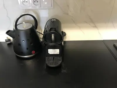 a tea kettle sitting on top of a table at Best of Azory apartment in Kraków