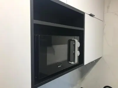 a microwave oven in a kitchen with its door open at Best of Azory apartment in Kraków
