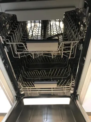 an empty dishwasher with its racks in it at Best of Azory apartment in Kraków