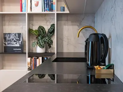 a tea kettle on a counter in a kitchen at Sage & Timber Apartment Kazimierz in Kraków