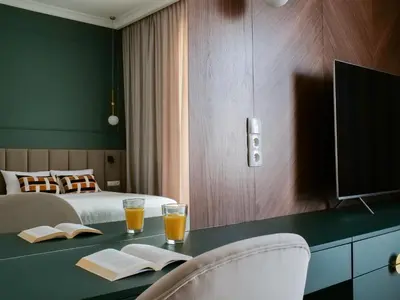 a hotel room with a table with two glasses of orange juice at Sage & Timber Apartment Kazimierz in Kraków