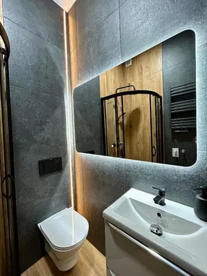 a bathroom with a sink and a toilet and a mirror at Ocean Black jacuzzi in Kraków