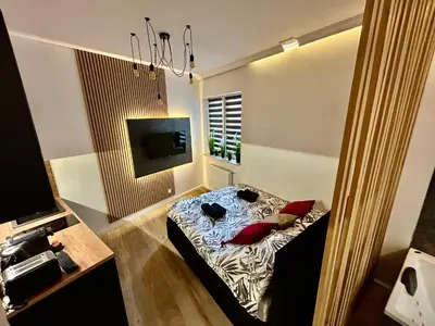a bedroom with a bed with red pillows at Ocean Black jacuzzi in Kraków