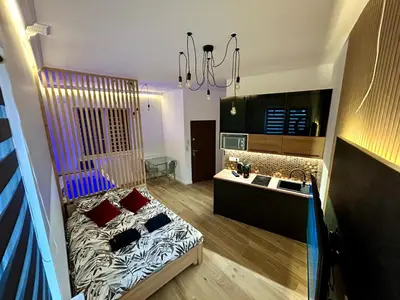 a room with a bed and a sink in it at Ocean Black jacuzzi in Kraków