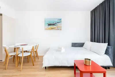 a hotel room with a bed and a table at Park Zakrzówek Cosy Studio by BookingHost in Kraków