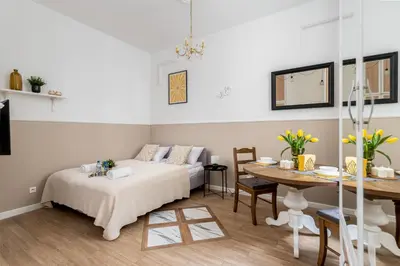 a living room with a bed and a table at Malila Premium Apartments City Center Kazimierz Starowiślna 41 in Kraków