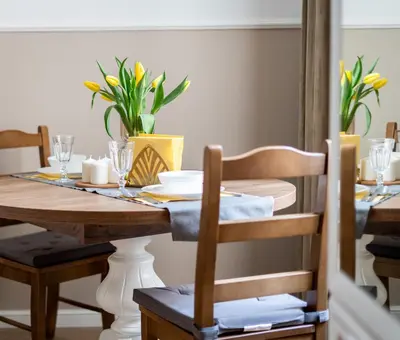 a dining room table with yellow flowers on it at Malila Premium Apartments City Center Kazimierz Starowiślna 41 in Kraków