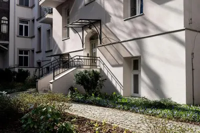 a white building with a staircase next to it at Malila Premium Apartments City Center Kazimierz Starowiślna 41 in Kraków