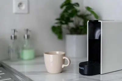 a coffee maker and a coffee cup on a counter at Malila Premium Apartments City Center Kazimierz Starowiślna 41 in Kraków