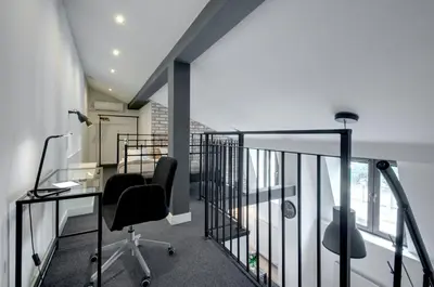 an office with a desk and chairs on a balcony at Zamkowa15 Apartments in Kraków