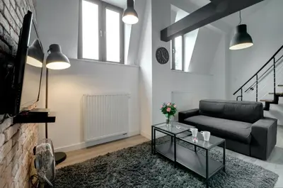 a living room with a couch and a table at Zamkowa15 Apartments in Kraków