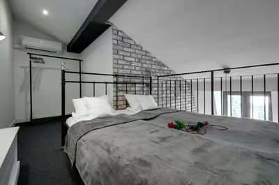 a bedroom with a large bed with white pillows at Zamkowa15 Apartments in Kraków