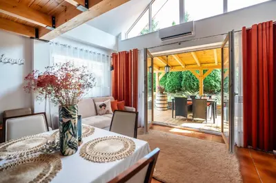 a dining room with a table with a vase at ForRest House Jacuzzi & Sauna in Jasienica