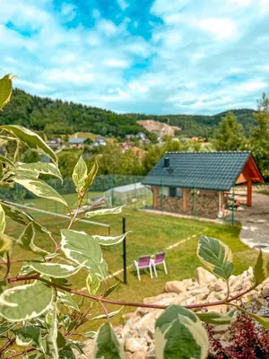 a garden with a purple bench in front of a house at ForRest House Jacuzzi & Sauna in Jasienica