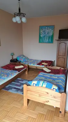 a room with three beds in a room at Zajazd-restauracja Zyga in Iwkowa