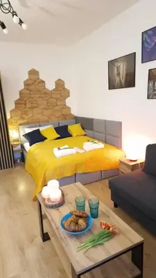 a bedroom with a bed and a table with food on it at Underground Cave Apartment in Wieliczka