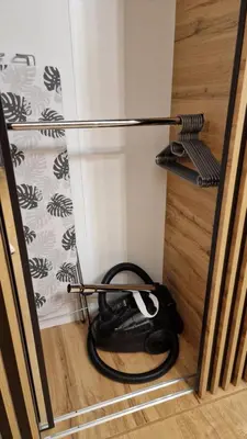 a room with a glass door with a controller on the floor at Underground Cave Apartment in Wieliczka