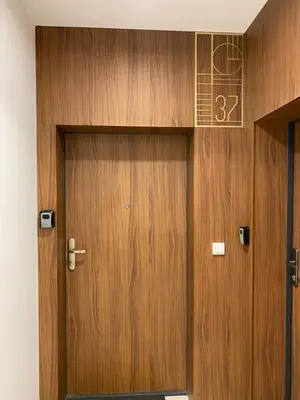 a wooden door with the number on it at Mimosa Kraków Apartment in Kraków