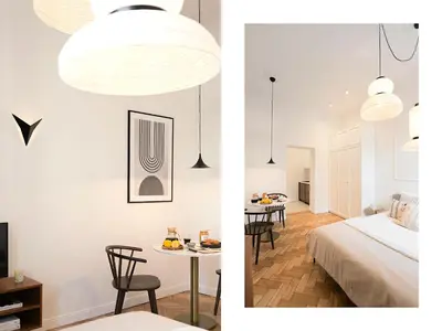 a bedroom and a living room with a bed and a table at Pędzichów Old Town Apartments in Kraków
