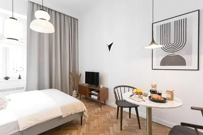 a bedroom with a bed and a table with food on it at Pędzichów Old Town Apartments in Kraków