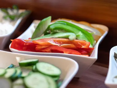 three bowls of vegetables are sitting on a table at Hotel Miodowa in Kraków