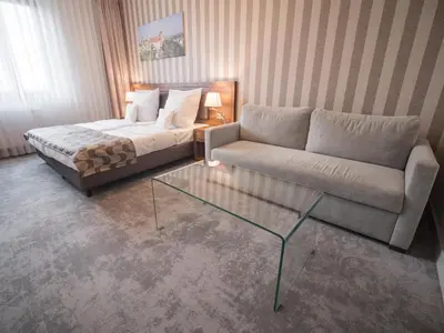 a living room with a couch and a coffee table at Hotel Miodowa in Kraków
