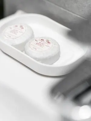 two rolls of toilet paper in a white bowl at Hotel Miodowa in Kraków
