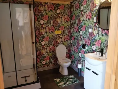 a bathroom with a toilet and a sink at Glamping Pogorzany - Jurty in Zabierzów