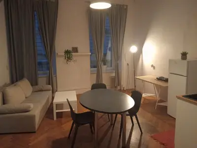 a living room with a table and a couch at Apartament Batorego in Kraków