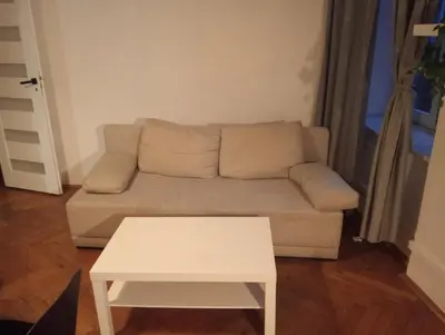 a living room with a couch and a table at Apartament Batorego in Kraków