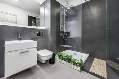 a bathroom with a toilet and a glass shower at Old Town Apartment Browar Lubicz Krakow in Kraków