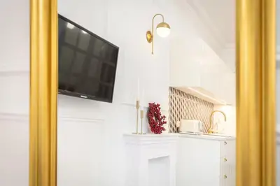a living room with a flat screen tv on a wall at Floriańska Old Town Apartments in Kraków