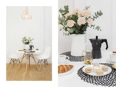 a dining room with a table and a vase with pink flowers at Radziwiłłowska Old Town Apartments in Kraków