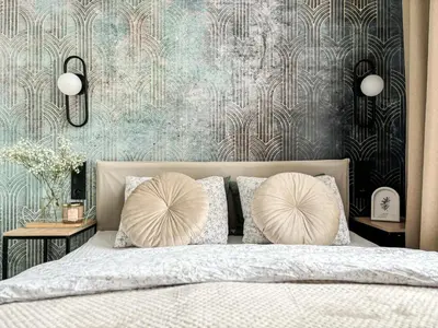 a bedroom with a bed with two pillows on it at LION apartments - PLATINIUM in Kraków
