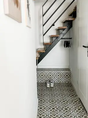 a hallway with a staircase and a tiled floor at LION apartments - PLATINIUM in Kraków