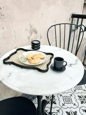 a table with a plate of food and a cup of coffee at LION apartments - PLATINIUM in Kraków
