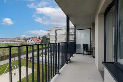 a balcony with a view of a building at Prokocim Kosocicka Apartment by BookingHost in Kraków