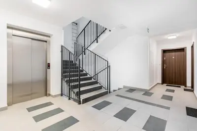 a hallway with a staircase and a door at Prokocim Kosocicka Apartment by BookingHost in Kraków