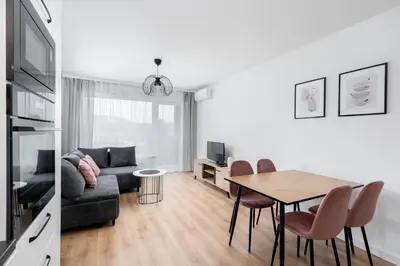 a living room with a table and a couch at Prokocim Kosocicka Apartment by BookingHost in Kraków