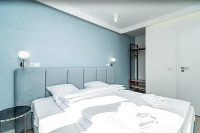 two beds in a room with blue walls at RentPlanet - Apartament Dębniki in Kraków