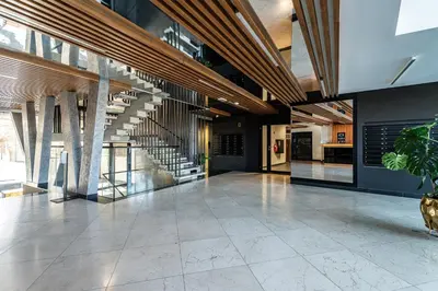 a large lobby with a staircase in a building at RentPlanet - Apartament Dębniki in Kraków